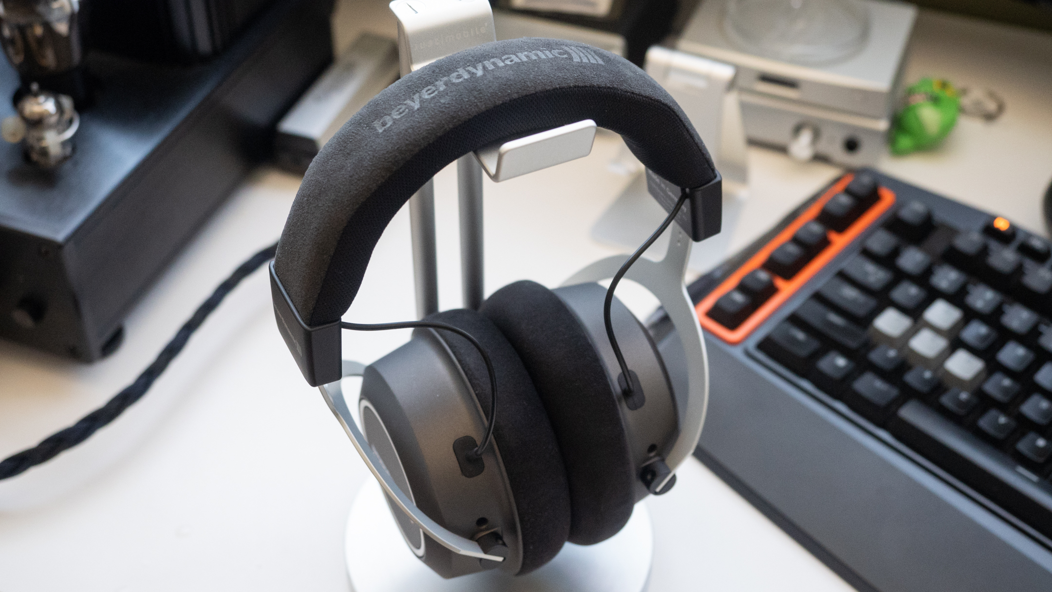 Ett par hodetelefoner av typen Beyerdynamic Amiron Wireless henger på et stativ.