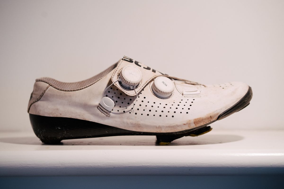 A white bicycle shoe on a shelf
