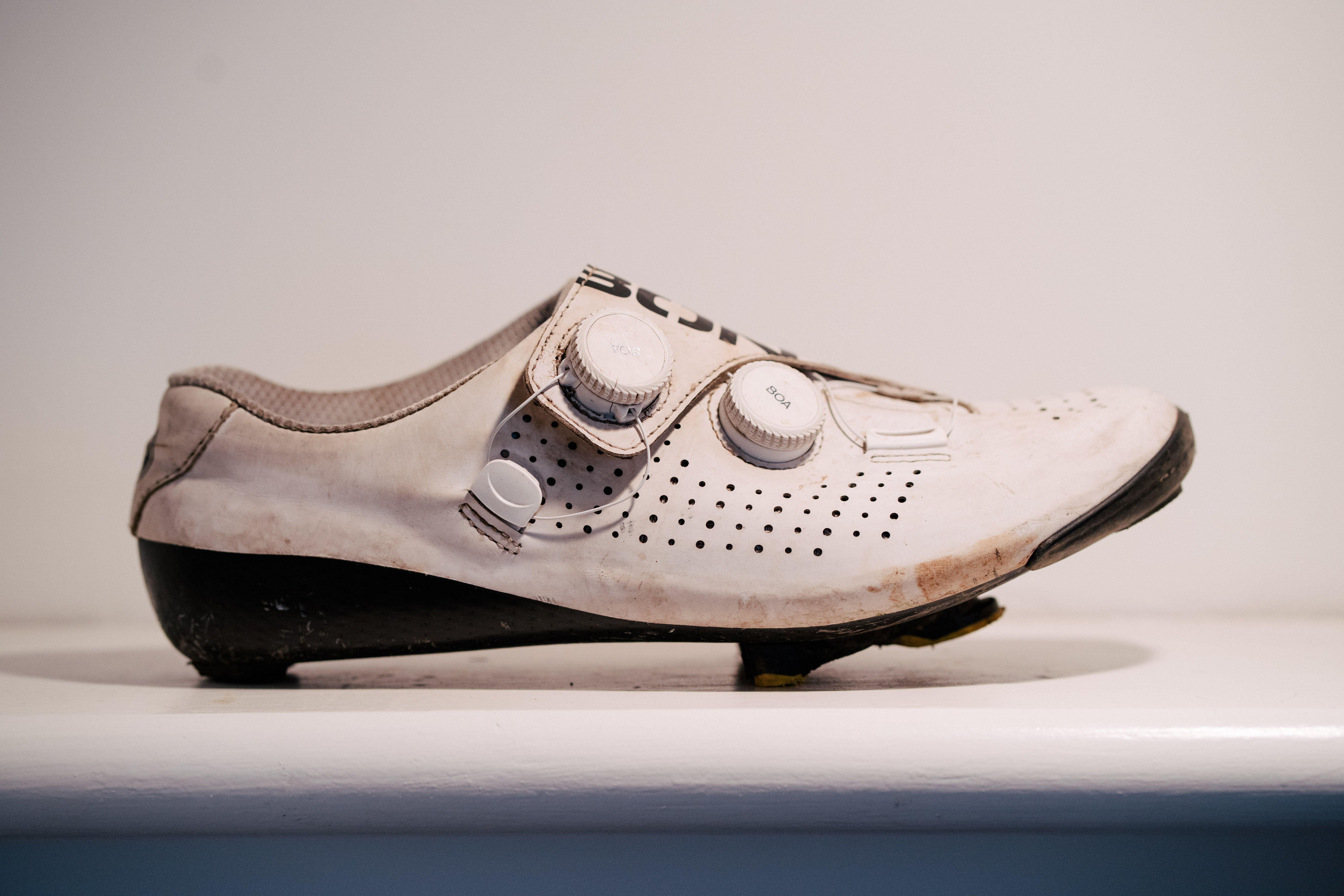 A white bicycle shoe on a shelf