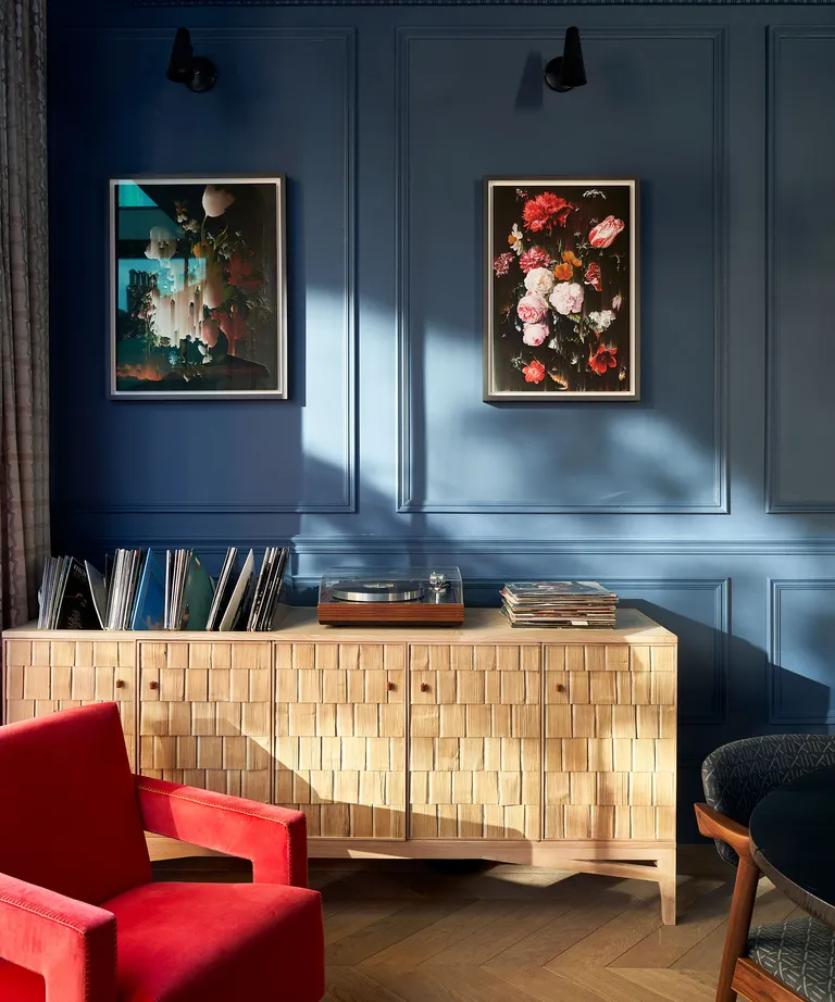 Living room with blue walls and wooden sideboard