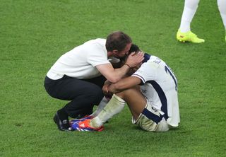 Gareth Southgate, Head Coach of England, consoles Jude Bellingham of England after defeat to Spain in the UEFA EURO 2024 final match between Spain and England at Olympiastadion on July 14, 2024 in Berlin, Germany.