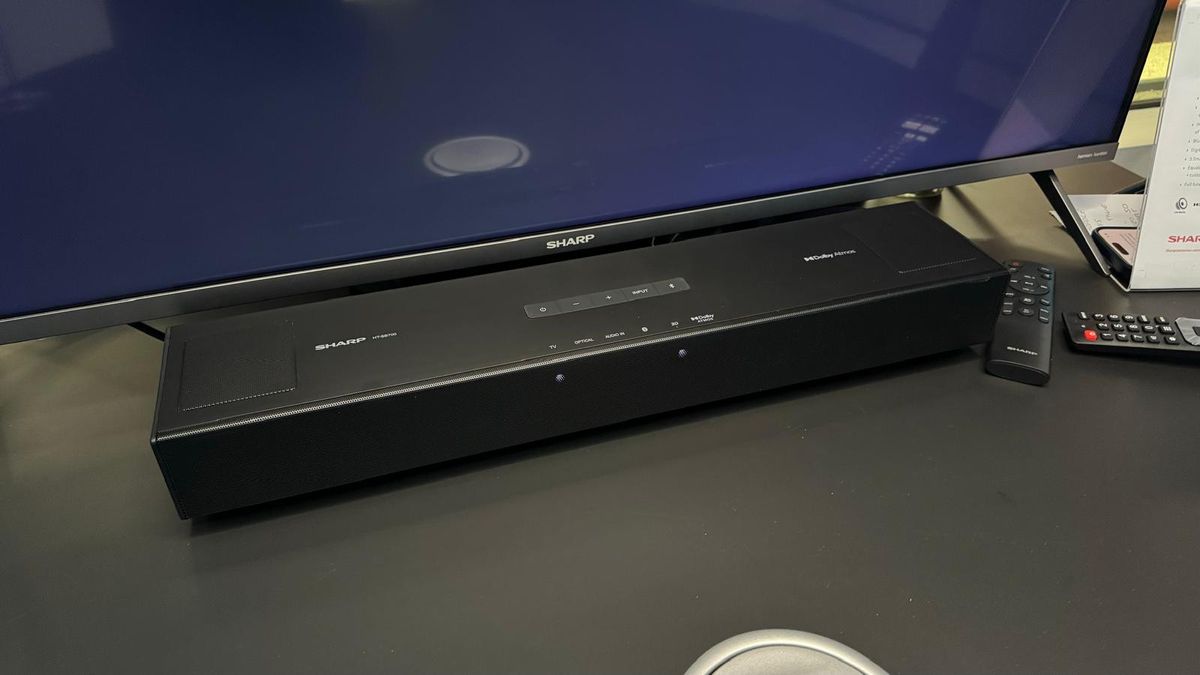 The Sharp HT-SB700 soundbar photographed on a desk in front of a Sharp TV