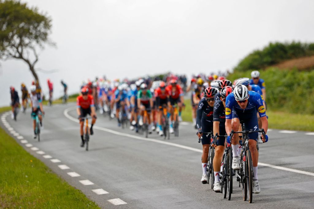 The pack rides during the 2nd stage of the 108th edition of the Tour de France cycling race 183 km between PerrosGuirrec and Mur de Bretagne Guerledan on June 27 2021 Photo by Thomas SAMSON AFP Photo by THOMAS SAMSONAFP via Getty Images