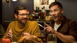 Bobby and Aaron share a joke over dinner in Bros
