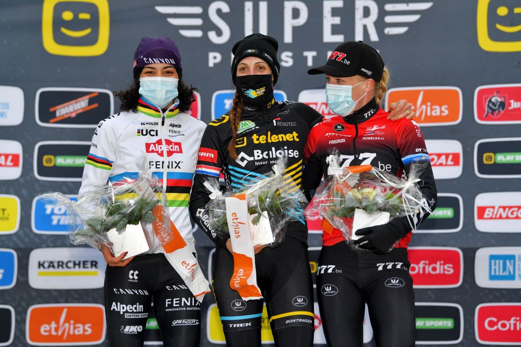 ZOLDER BELGIUM DECEMBER 26 Podium Ceylin Del Carmen Alvarado of The Netherland and Team AlpecinFenix Lucinda Brand of The Netherland and Team Telenet Baloise Lions Annemarie Worst of The Netherland and Team 777 Celebration Mask Covid safety measures Flowers during the 16th HeusdenZolder World Cup 2020 Women Elite CX SPHeusdenZolder SuperprestigeCX Cyclocross on December 26 2020 in Zolder Belgium Photo by Luc ClaessenGetty Images