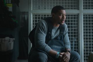 aaron pierre sitting in a locker room in a still from rebel ridge