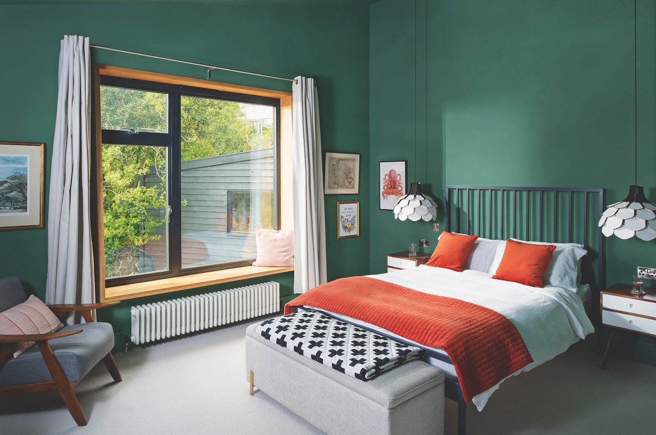 large windows in dark green bedroom