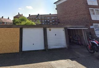 A set of garages next to some houses