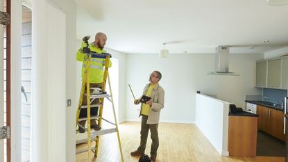 Contractor and landlord making final repairs