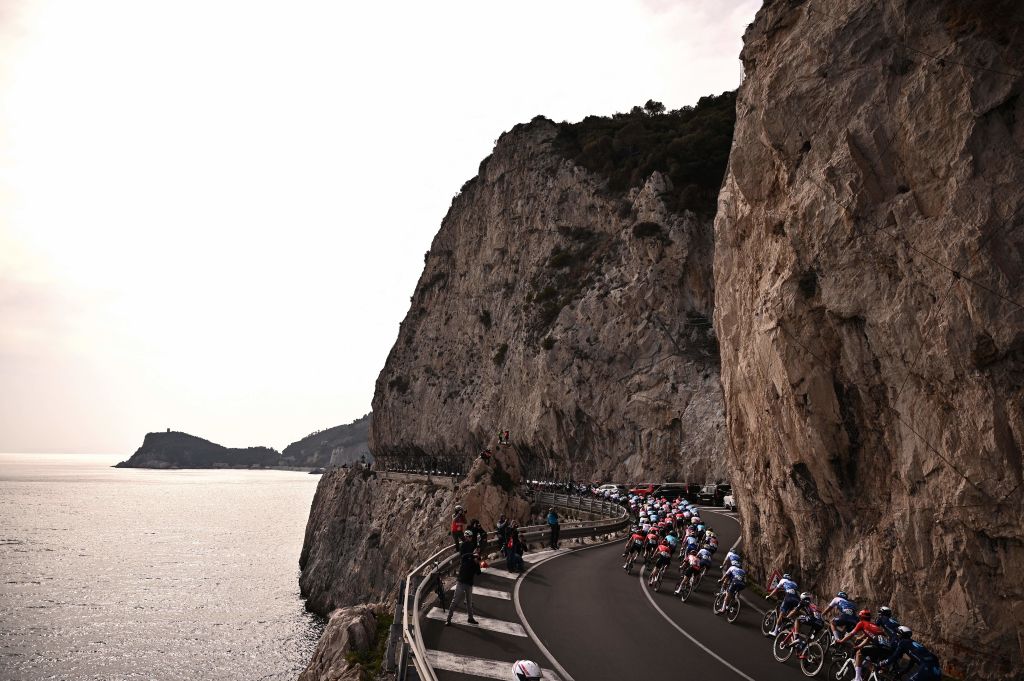 The pack rides along the coastline near Varigotti Liguria during the 113th MilanSan Remo oneday classic cycling race on March 19 2022 between Milan and San Remo northern Italy Photo by Marco BERTORELLO AFP Photo by MARCO BERTORELLOAFP via Getty Images