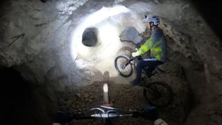 Mountain bikers underground in a mine shaft