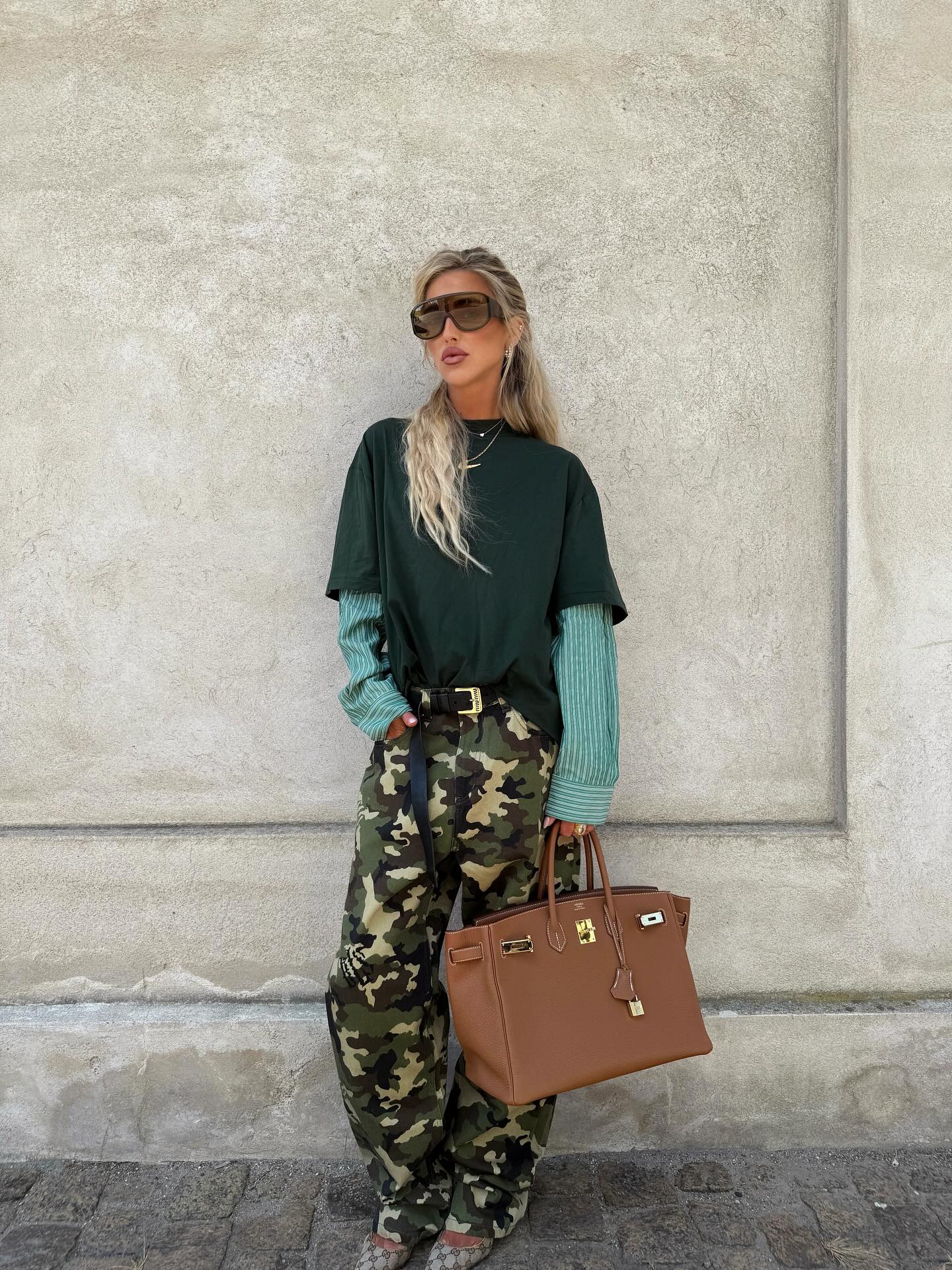 A woman wearing a camo-pant outfit in 2026.