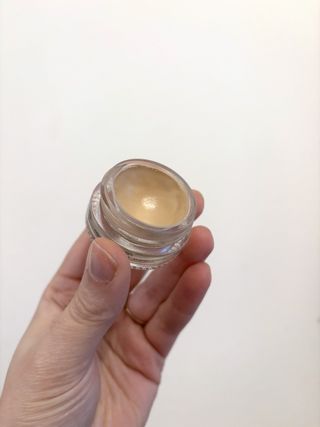 Mica Ricketts holding Glossier Stretch Balm Concealer