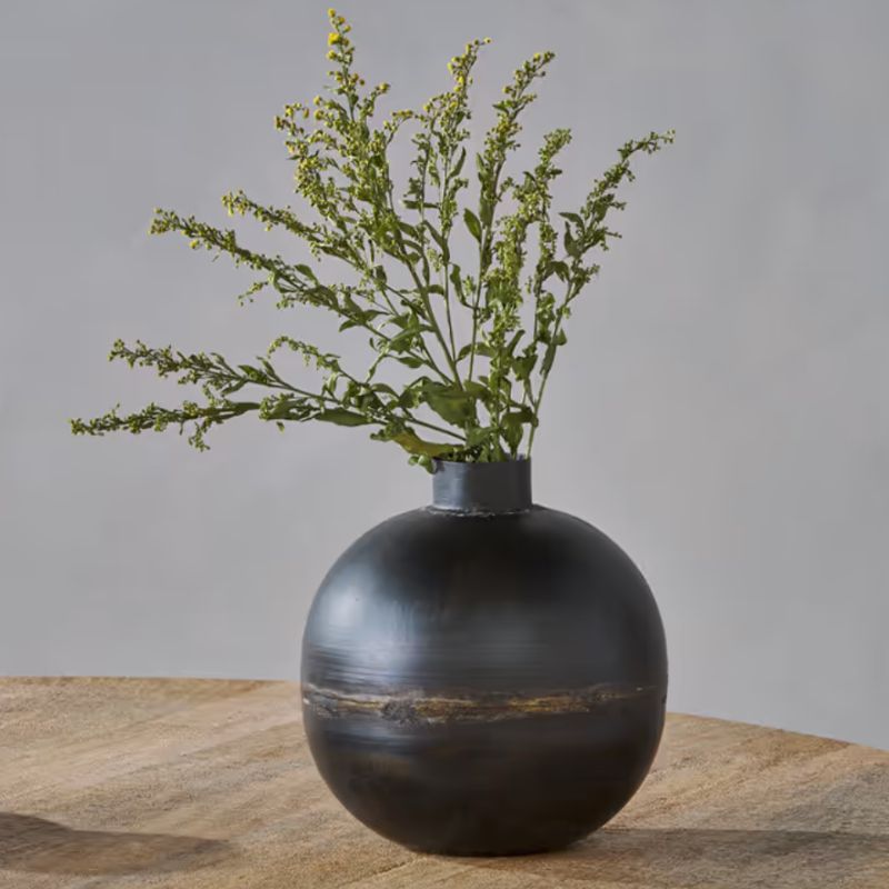 black rounded vase with stems