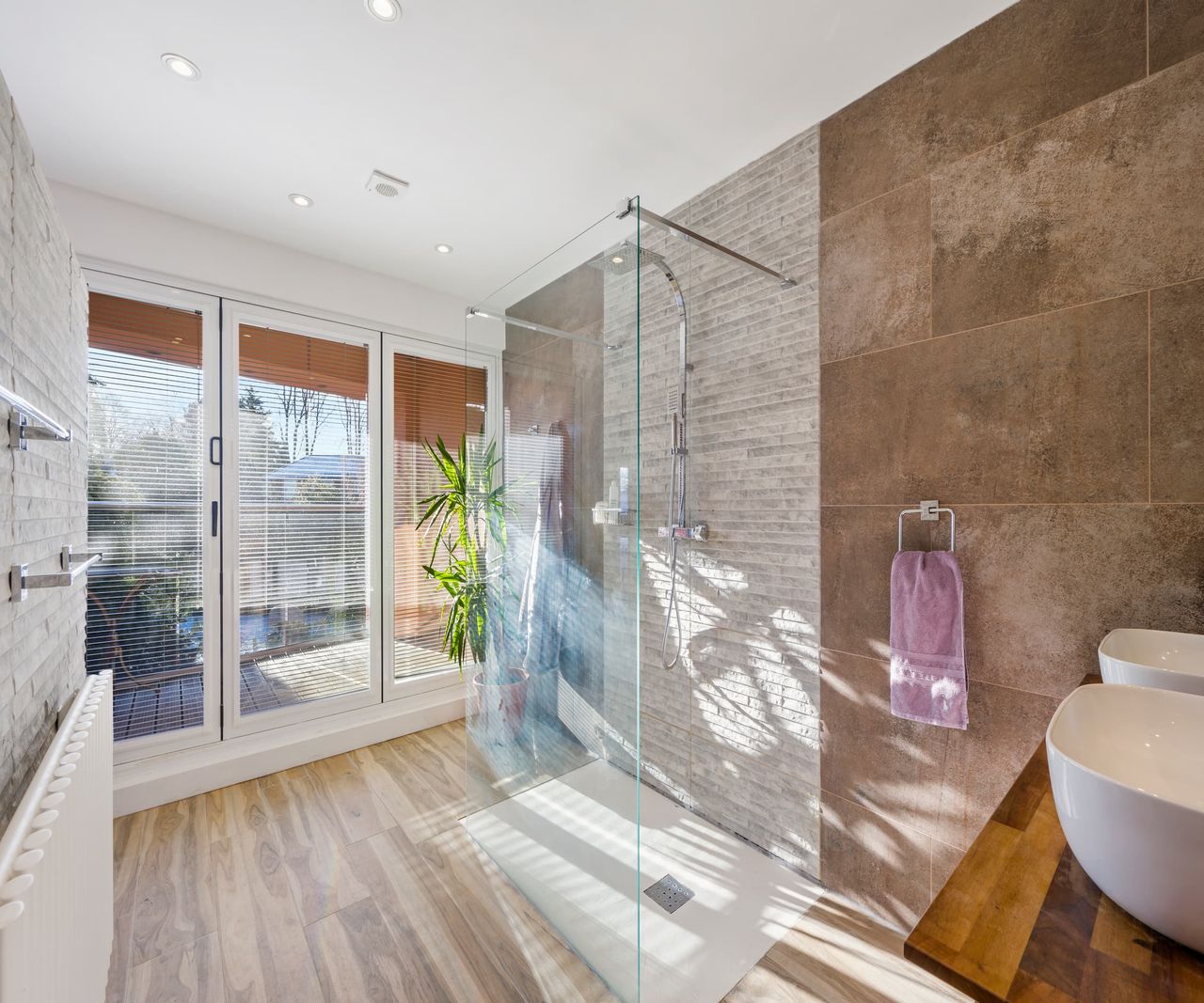 A free standing clear window shower and tiled walls