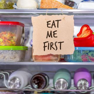 food in fridge with 'eat me' sign