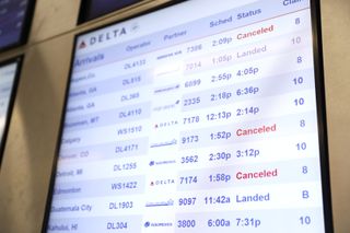 A screen at the airport showing some flight cancelations