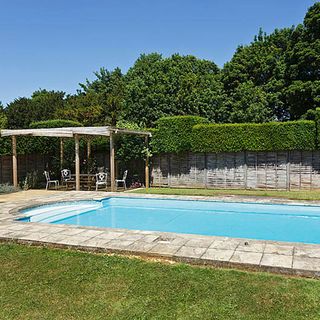 swimming pool with water and table with chair