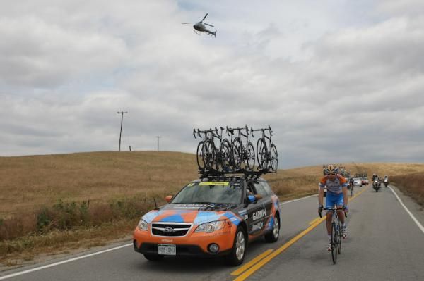 Peter Stetina grabs a bottle from the Garmin-Transitions car.