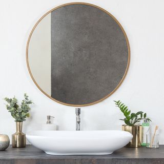 hykkon kobe accent mirror above a sink in white bathroom