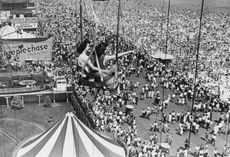 Vacationers on a fairground ride at Coney Island.