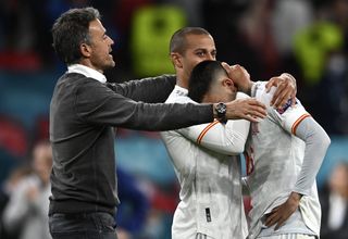 Luis Enrique, left, consoles his beaten players