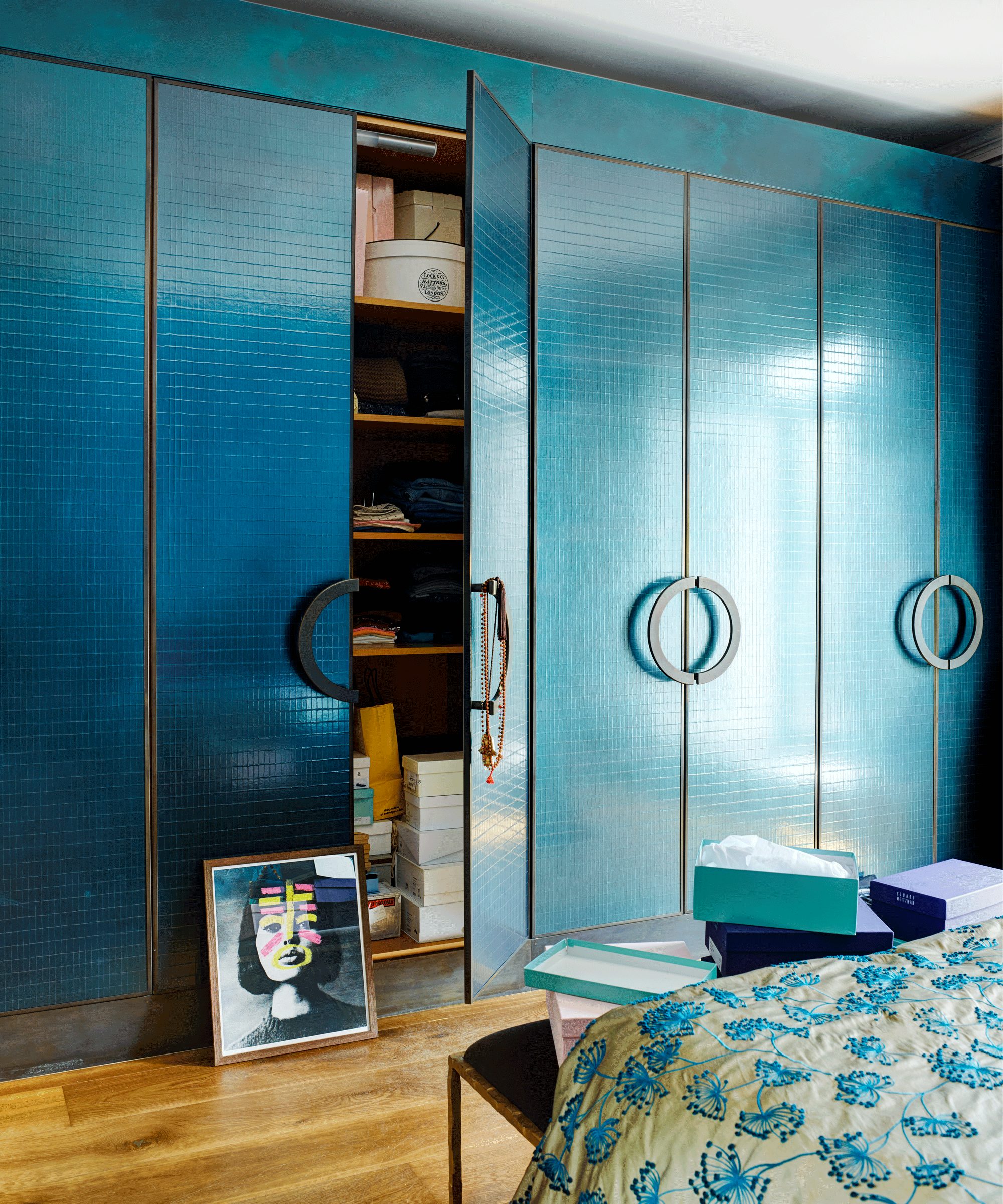 Bedroom with teal floor to ceiling wardrobes