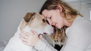 Dog owner and her dog, embrace