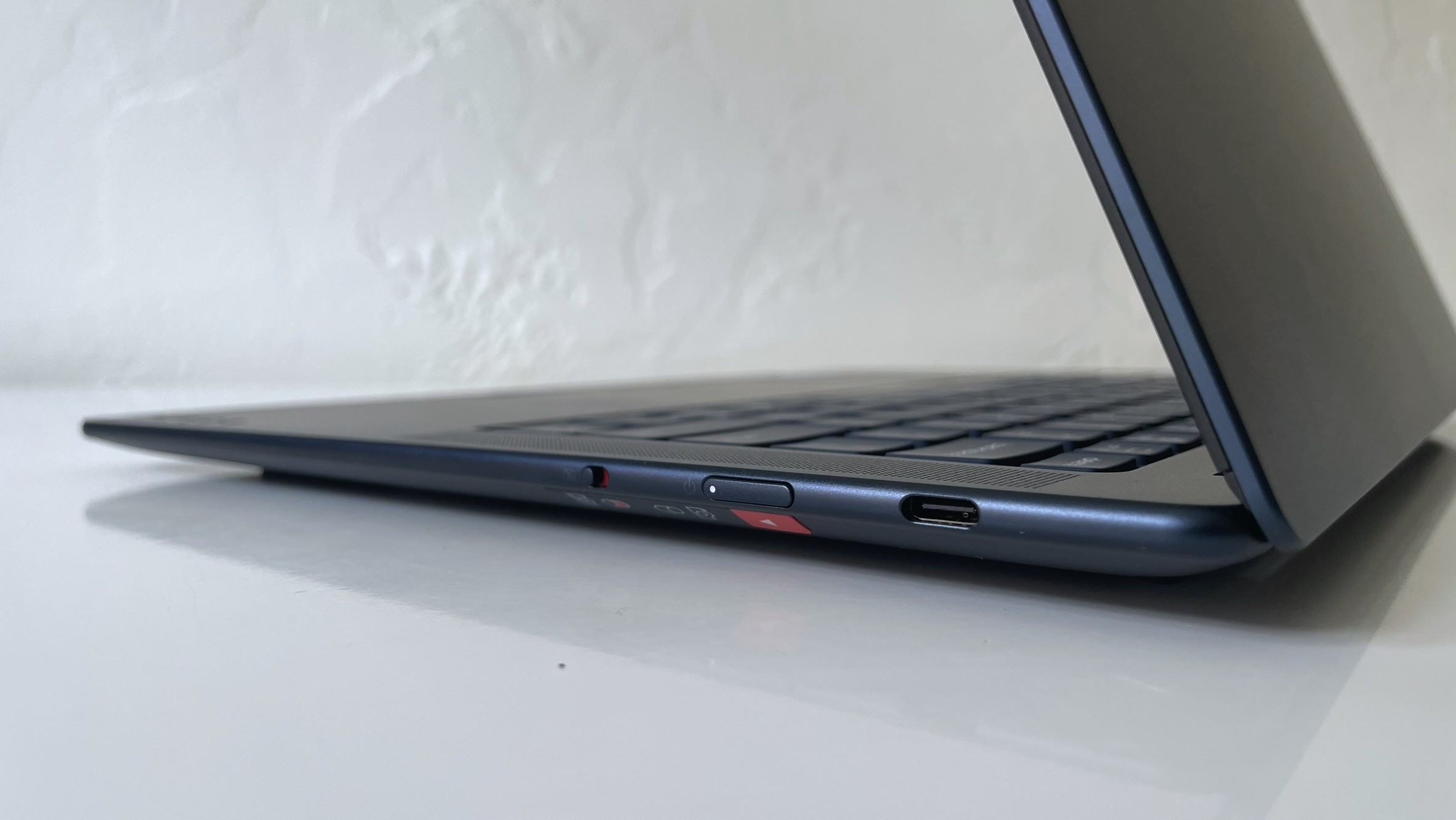 Close up of the ports on the right side of the Lenovo Yoga Slim 7x seen on a white desk