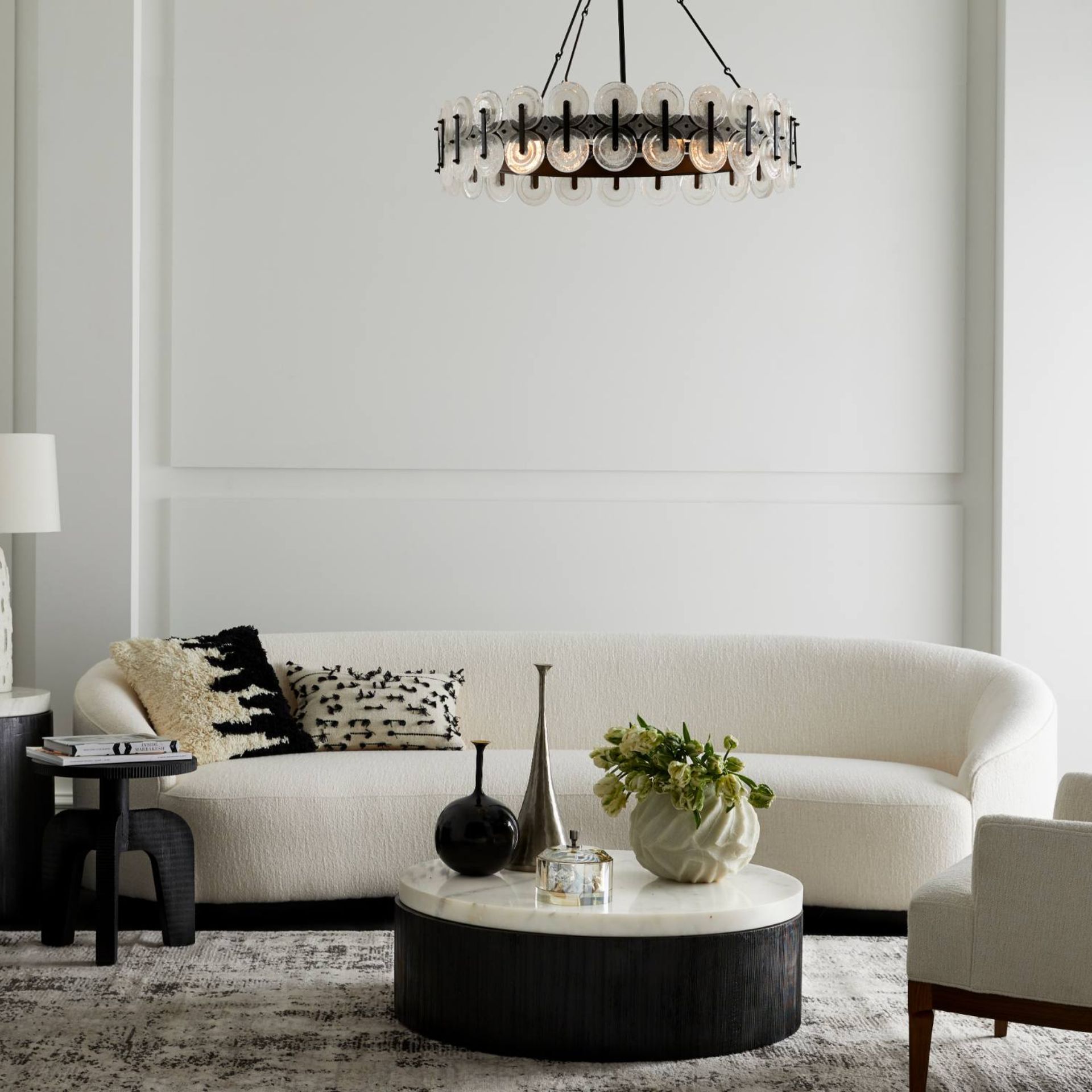 Arteriors x Laura Kirar Rondelle chandelier and Turner sofa