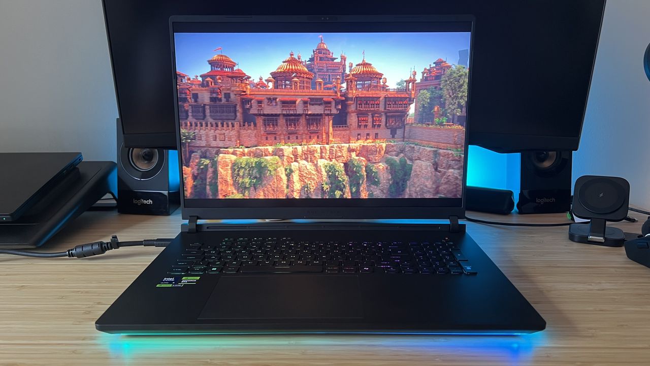 Asus ROG Strix Scar 18 gaming laptop running Horizon Zero Dawn Remastered on a wooden desk