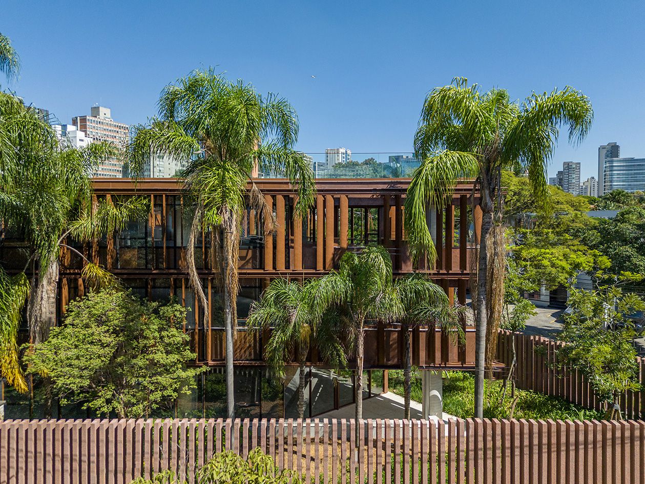 building with corten steel louvres surrounded by trees