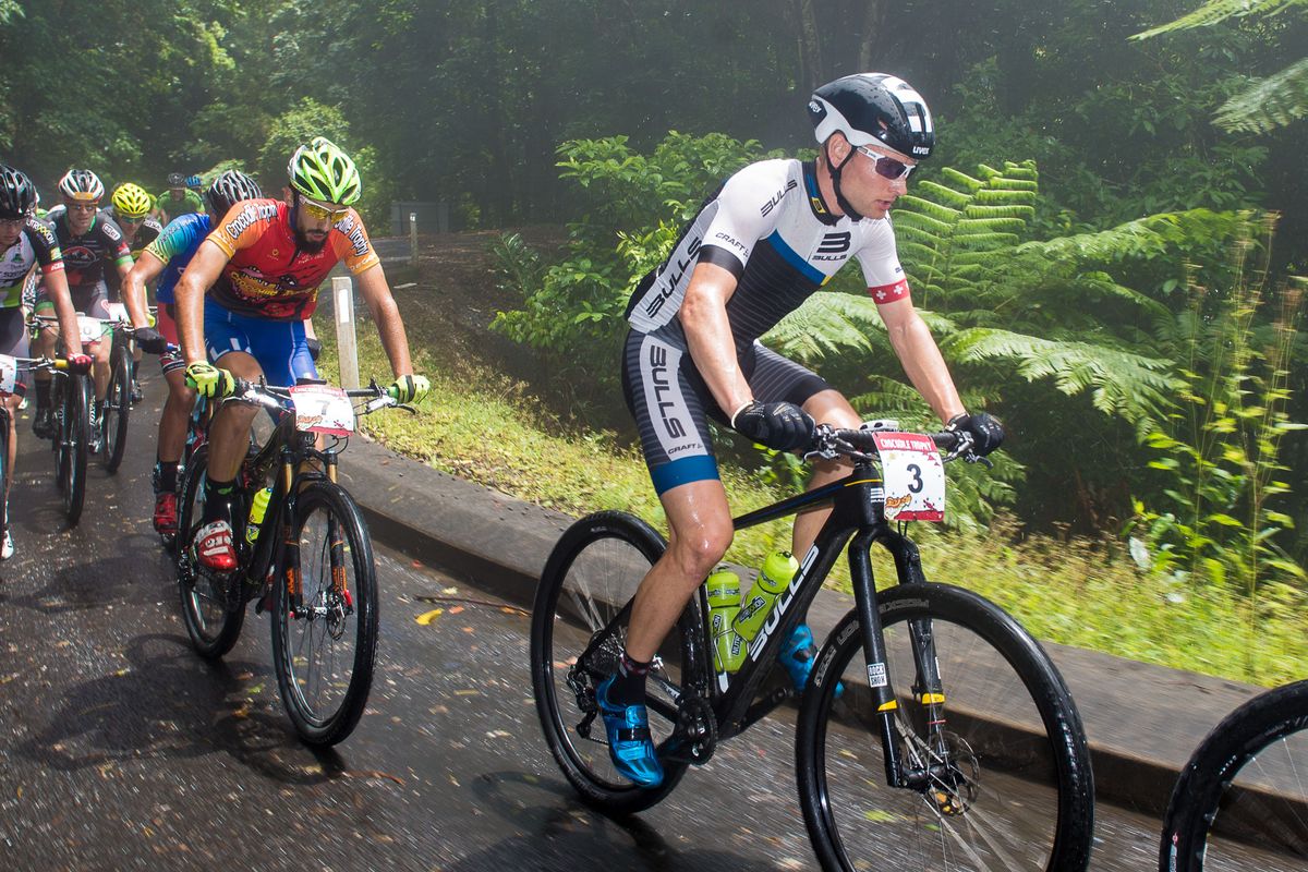 A misty morning for Urs Huber on the climb to Copperlode Dam, Nicholas Pettina on his wheel
