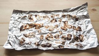 Crumpled aluminium foil used for cooking stained with food residue