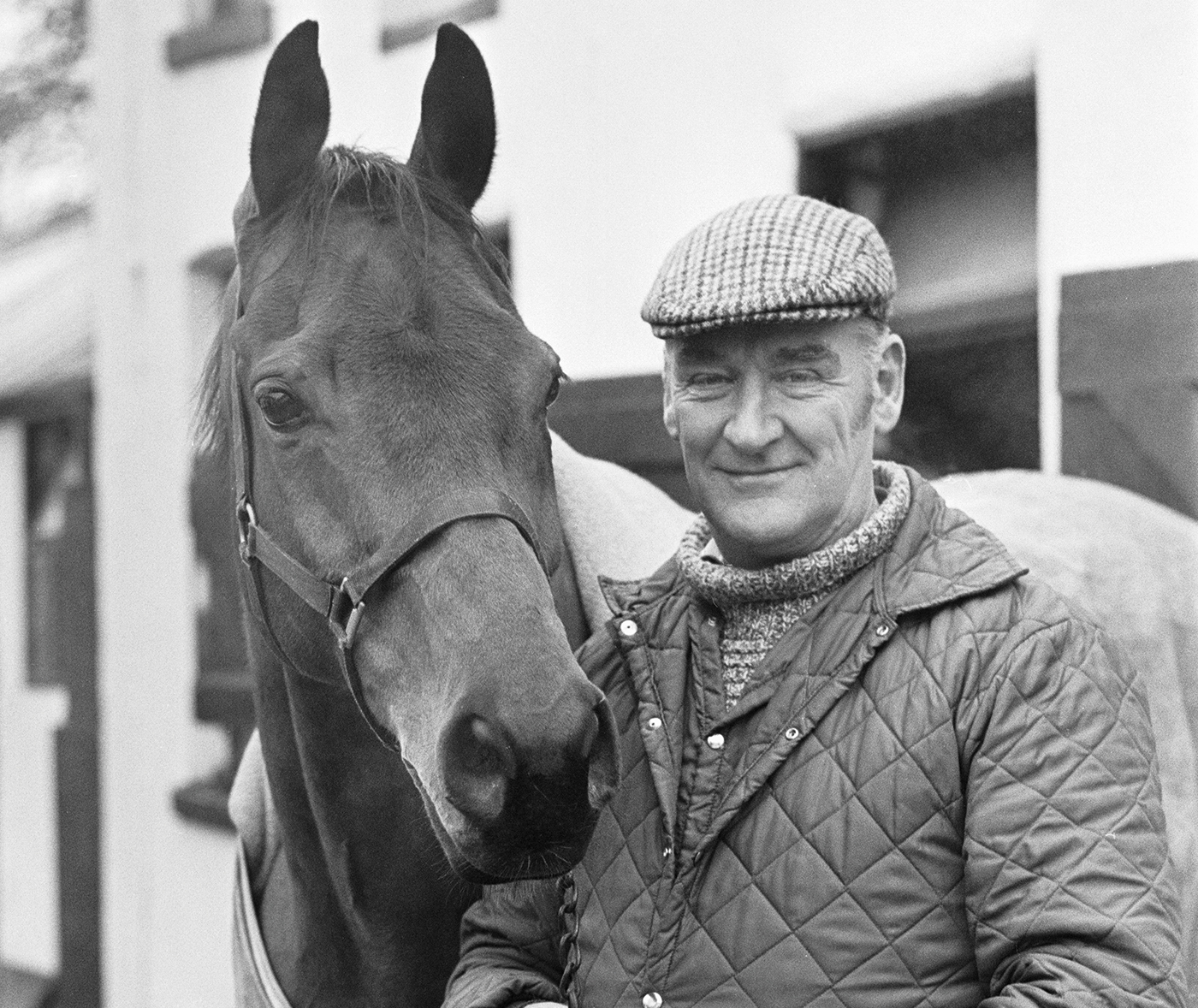 EJNFNB Donald Ginger McCain, the trainer of three times Grand National winner Red Rum, pictured with the famous racehorse at their stables in Birkdale, Southport in Merseyside. 13th January 1978.