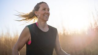 Woman smiling in early morning sunlight doing an easy run