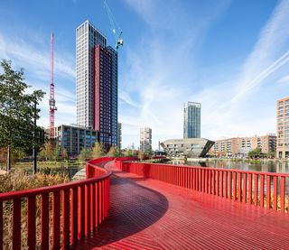 Asif Khan boardwalk at Canada Water bright red bridge across water and natural water wildlife habitat