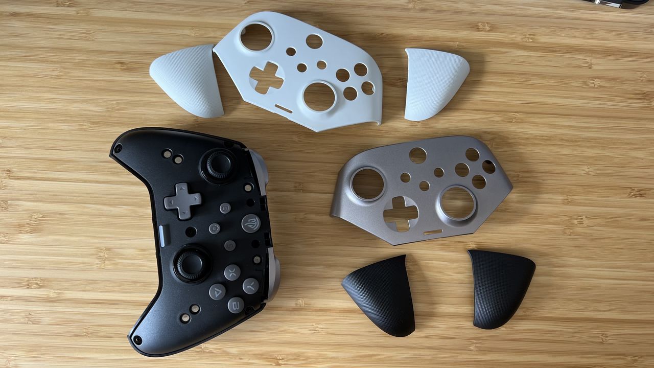 EasySMX X10 controller with different faceplates on a wooden table