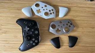 EasySMX X10 controller with different faceplates on a wooden table