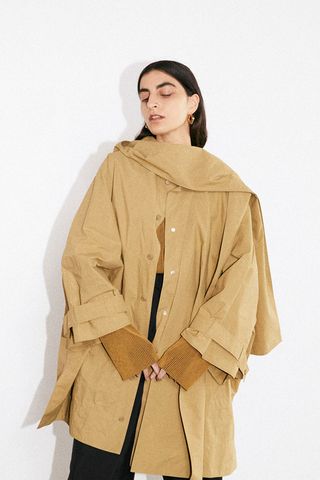 Model wears Aeron Pre-Fall 2021 camel jacket