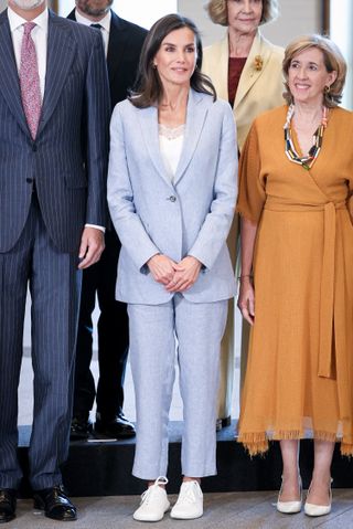 Queen Letizia of Spain in a blue linen suit with white sneakers at a board meeting with the Patronage of the Gallery of the Royal Collections in Madrid, Spain May 2024