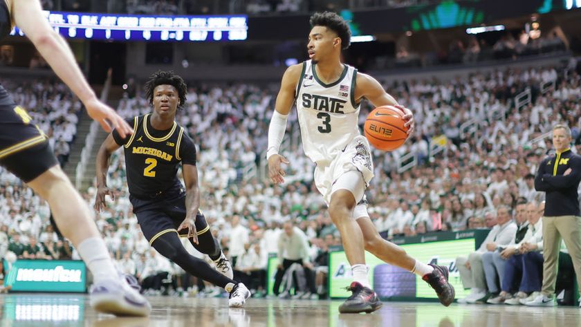 Jaden Akins #3 of the Michigan State Spartans drives to the basket against L.J. Cason #2 of the Michigan Wolverines in March 2025