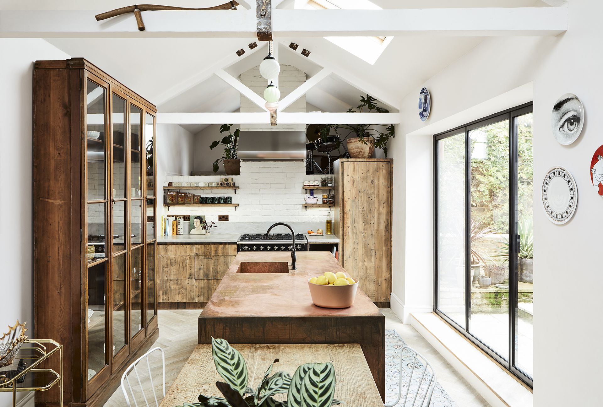 kitchen with wooden cabinetry and copper island facing patio doors