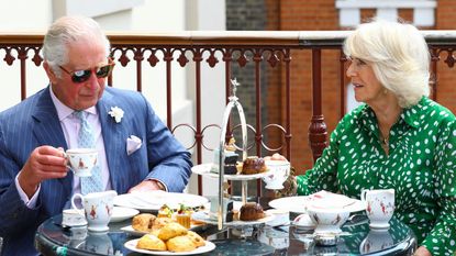 Charles and Camilla eating afternoon tea