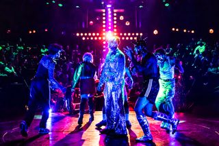 a scene in romeo and juliet on broadway of the cast wearing sparkly clothes and masks