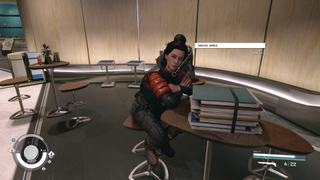 Starfield companions - Shot of woman sitting at a table with a stack of books on it