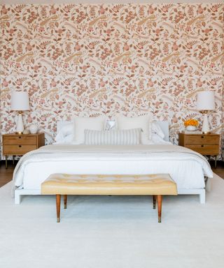 bedroom with white bedding and coral wallcovering