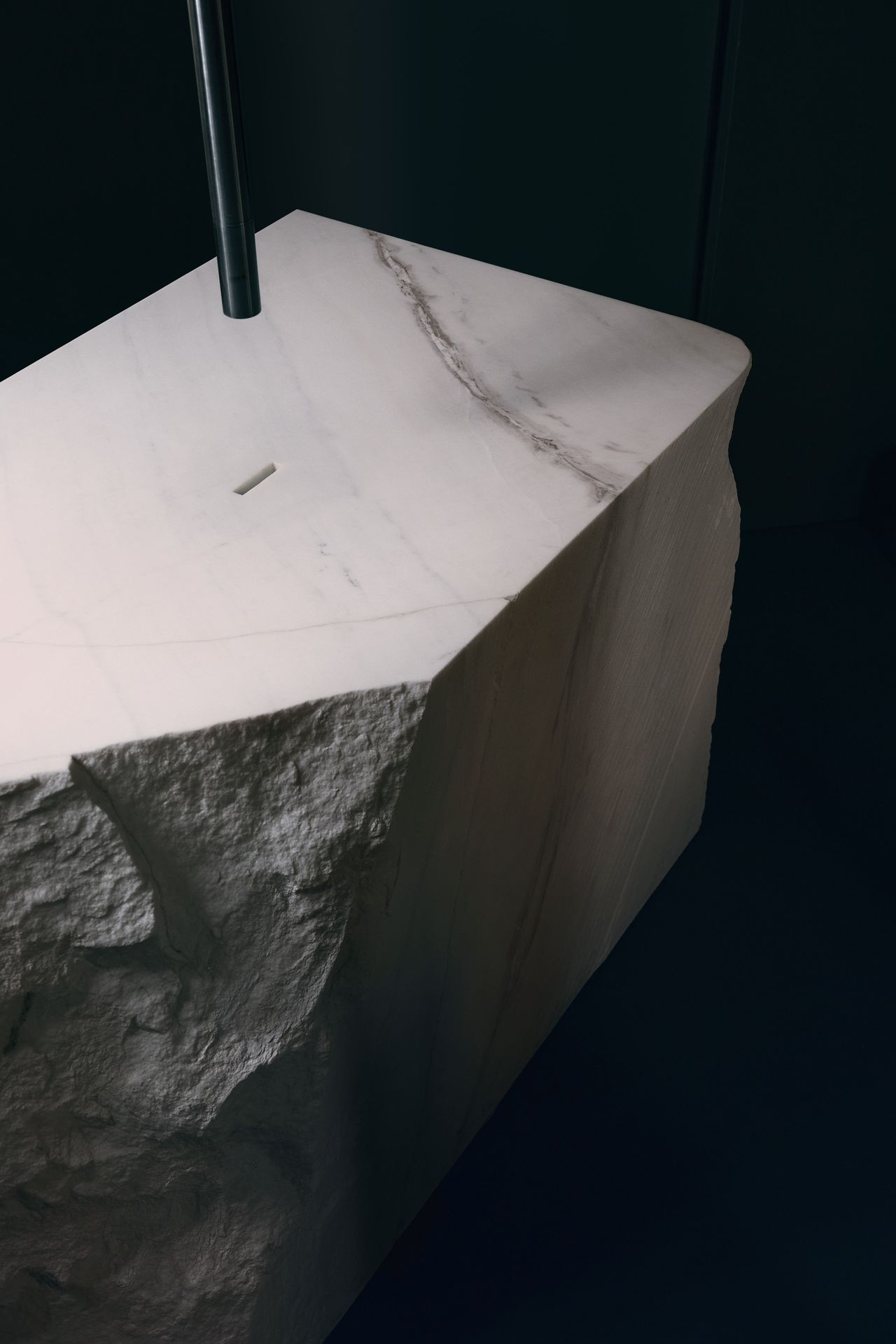 The guest bathroom is dominated by the vast marble sink