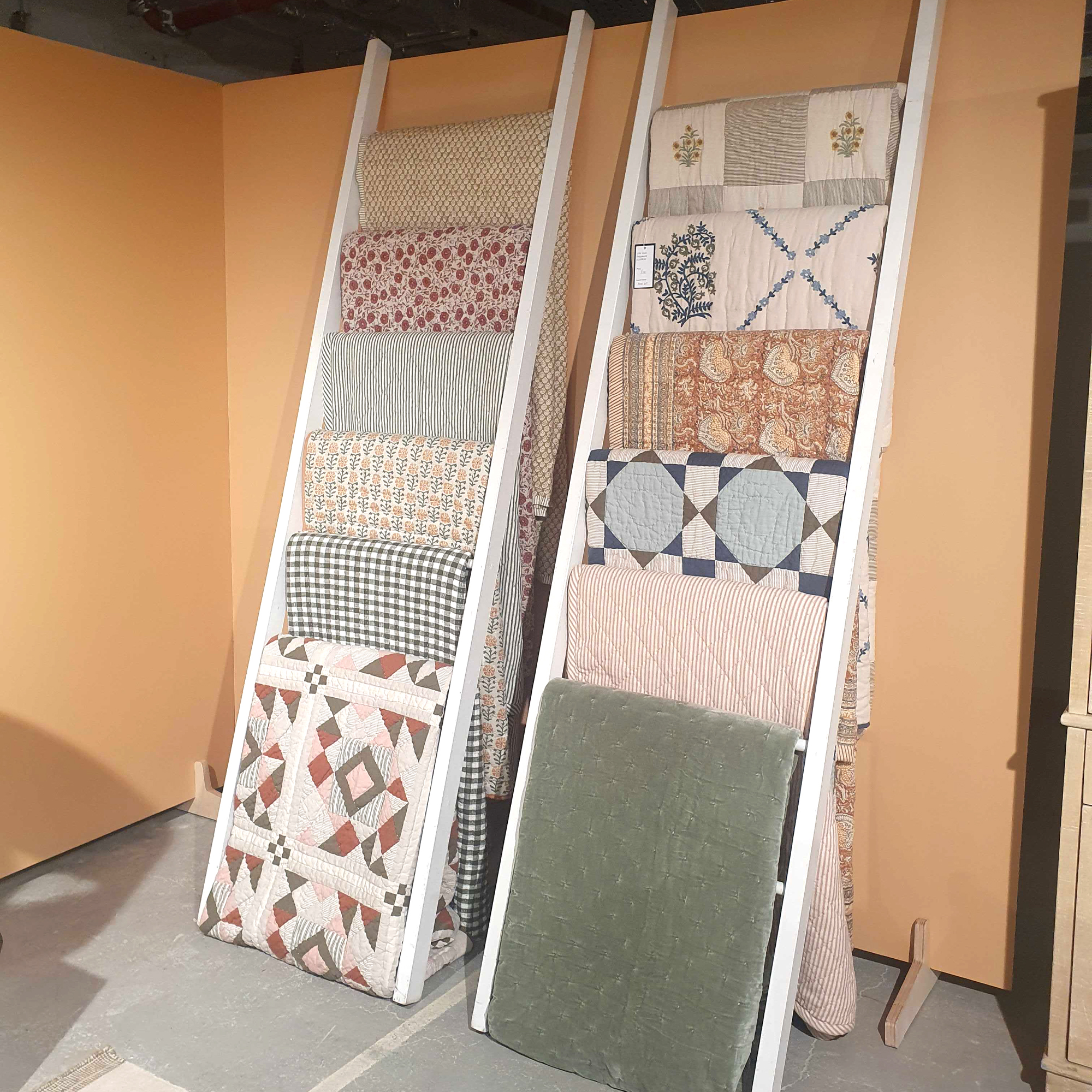 The John Lewis quilt range hanging on display ladders at the John Lewis Press Day Preview