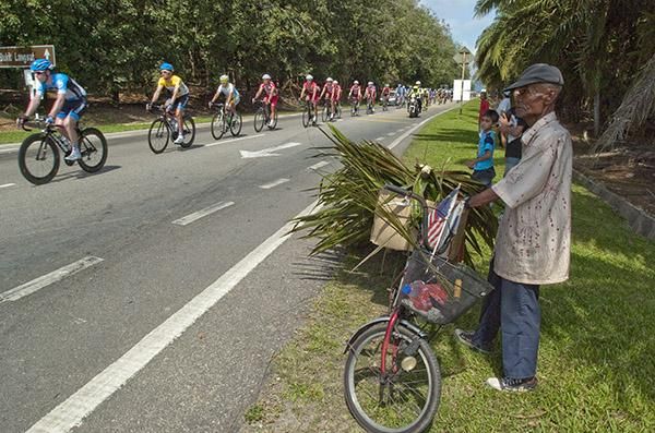 A local stopped to watch the tour go by.
